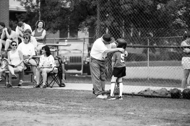 Tori and her dad at a softball game